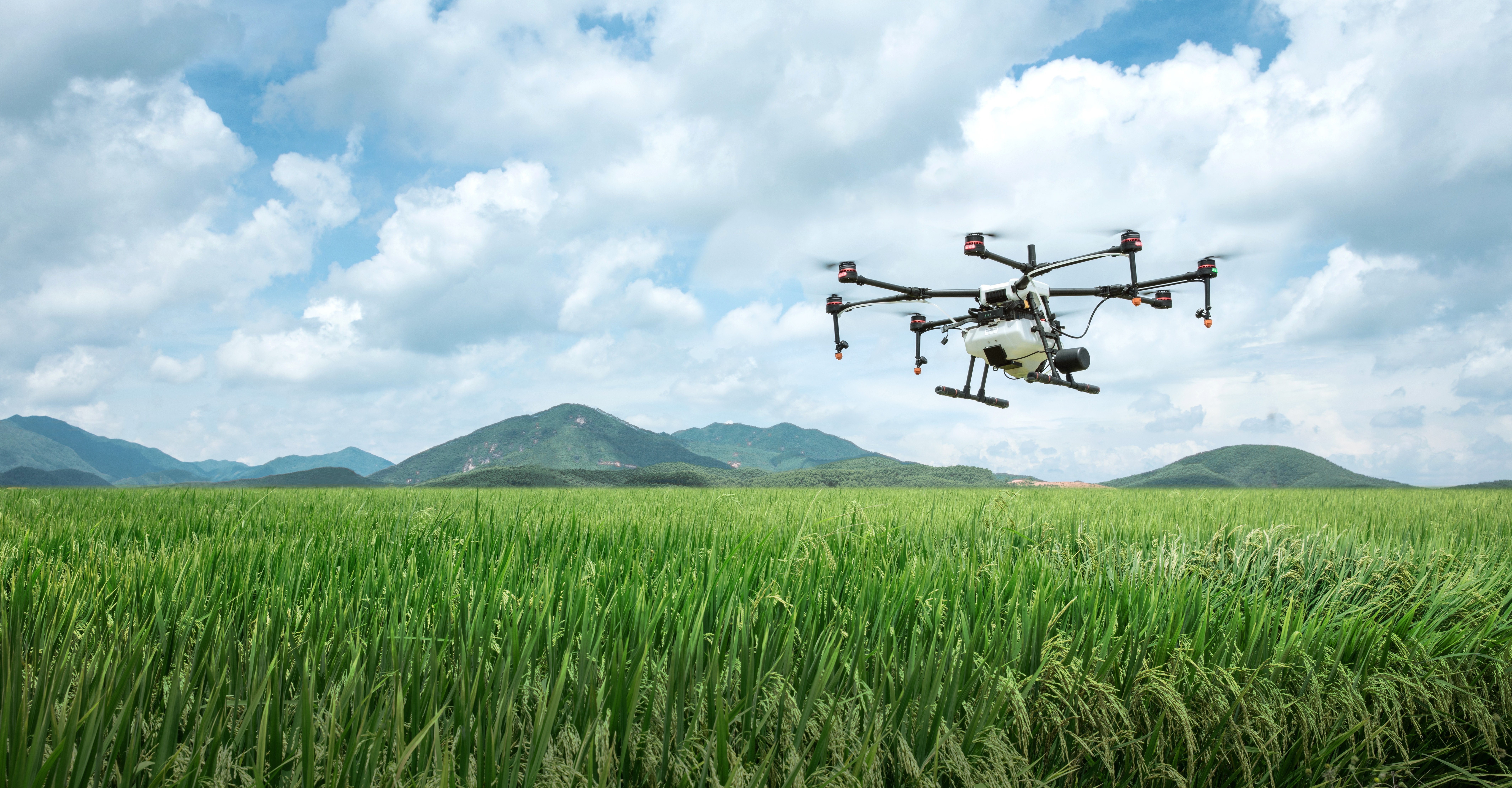 Agricultural drone flying over lush green fields in Kenya